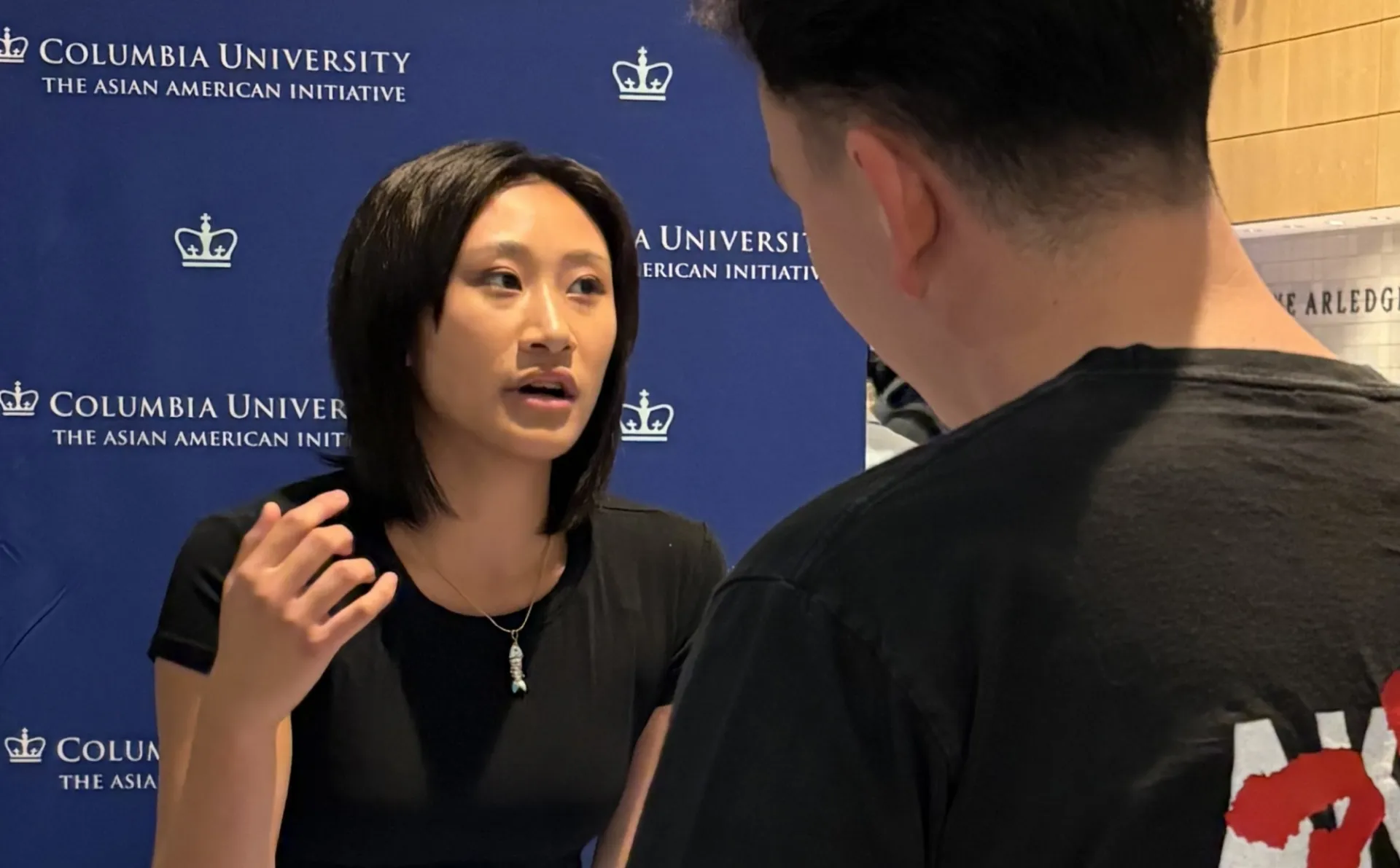 Emily Kam talking to a student interested in joining AAI